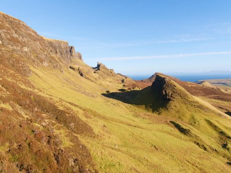 Winter colors of hilly landscape on the Isle of Skye in Scotland. Beautiful Quiraing range of mountains within sunny February day