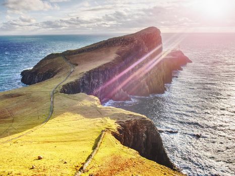 Famous look at Lighthouse on the cliff of Neist Point, rugged and rocky coast on the western side Isle of Skye, Scotland, United Kingdom, Europe