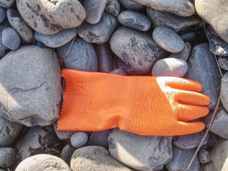 Dangerous garbage ejected from the sea on remote beaches. Environmental contamination with toxic mess.