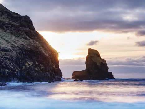 The rest of the day in rocky bay. Evening light on the rocks, boulders and cliff face of Talisker Bay, Isle of Skye