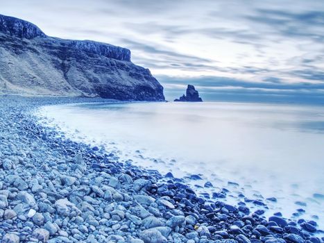 Rocky coast of sea. Slow shutter speed for smooth water level. Visite Talisker Bay on the Isle of Skye in Scotland at sunset