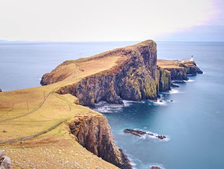 Neist Point Lighthouse, famous photographers location on the Isle of Skye in Scotland.  Melancholy morning after rainy night.