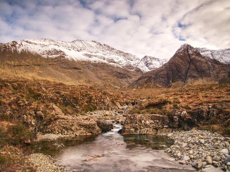 Legendary Fairy Pools at Glenbrittle at the foot of the Black Cuillin Mountains. Small waterfall with colorful pools,  Isle of Skye, Scotland