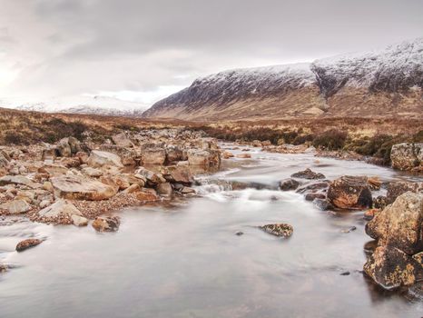 Mystic atmosphere awithin trek t River Etive in Glencoe moutains In Winter.  Cold windless winter morning