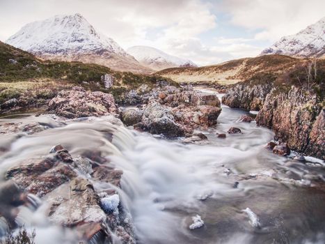 Spring river in Scottish highlands.  Dramatic landscape of Glen Coe during early spring, Scotland