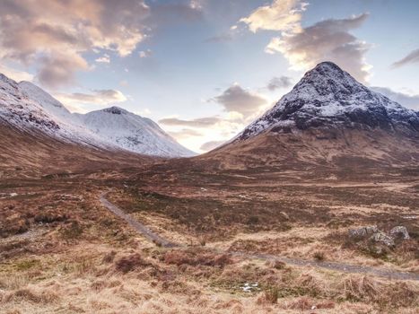 Snowcapped mountains in Scottish Highlands near Glencoe, Scotland. Fresh snow covered peaks of mountains.