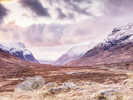 Snowcapped mountains in Scottish Highlands near Glencoe, Scotland. Fresh snow covered peaks of mountains.