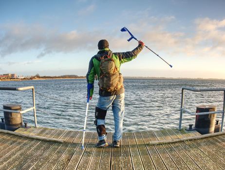 Man lookking over silent sea to horizon. Tourist in harbor