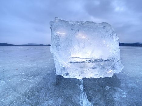 Natural ice blocks. Ice floe breaking due to strong wind against the shore and move. Freezing winter weather.