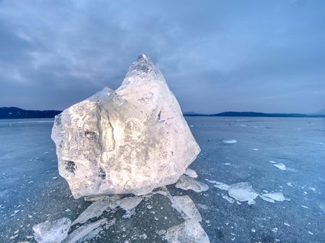 Natural ice blocks. Ice floe breaking due to strong wind against the shore and move. Freezing winter weather.