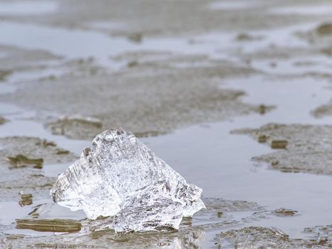 Cracked glacier ice in close-up detail. Natural ice pattern structure with natural baackground. Winter detail