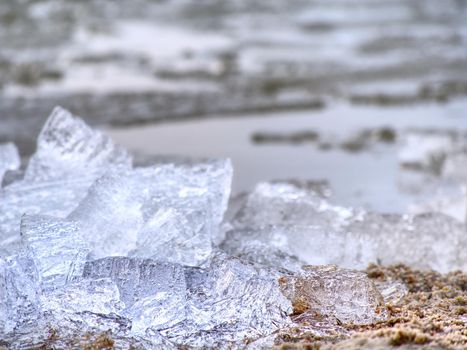 Tourist attraction disappearing Glaciers. Visible climate Change. Icy floes mealtiing on beach. Ice on the black volcanic sand.