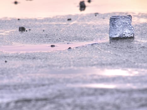 Broken floes and  iceberg. A large ice piece on freshwater ice that has broken off a glacier or an ice shelf. Reflection in ice