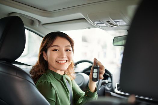 Young asian woman buying new car