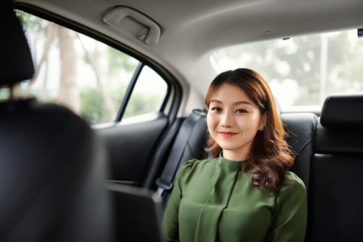 Beautiful young attractive business woman is working on her laptop while traveling to work