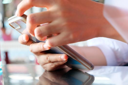 close up image of Teenage girl text messaging on her phone