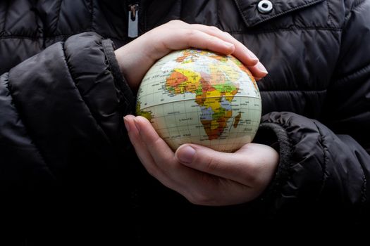 Businessman is standing with an earth globe fot business concept