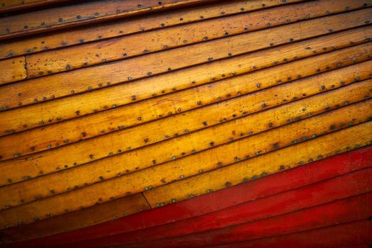 An abstract of the freeboard and draft of a small wooden boat showing the planks and panels.