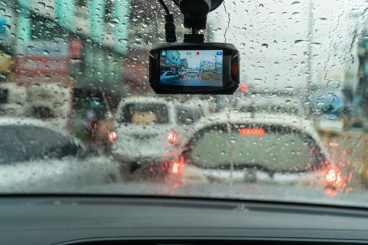 Raindrops on windshield from inside the car in traffic jam