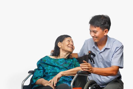 Son looking after elderly mother on wheelchair