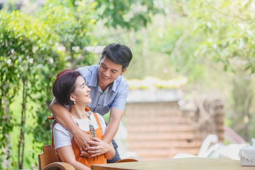 Asian middle-aged man relaxing with his wife in anniversary wedding day