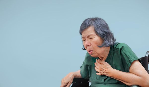 elderly woman cough ,choke on wheelchair