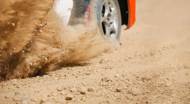 Rally racing car on dirt track.