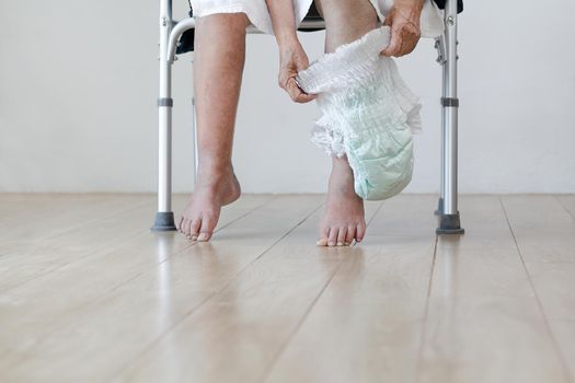 elderly woman changing diaper