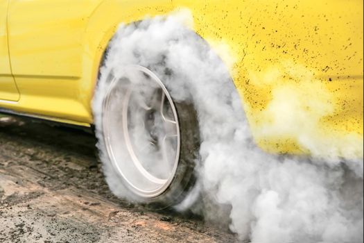Drag racing car burns rubber off its tires in preparation for the race