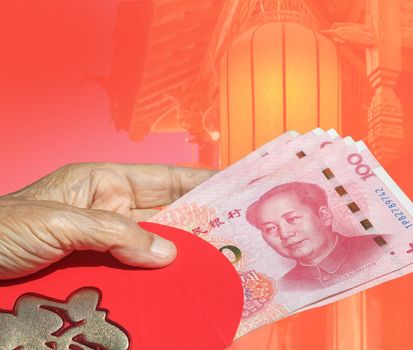 Grandmother holding red envelope chinese new year or hongbao , text on envelope meaning good luck