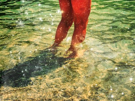 Bare foot legs in the crystalline water in the summer.  Abstract.