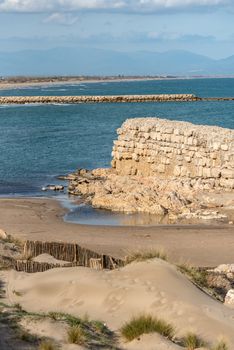 Grec Wall in Platja de Les Muscleres in La Escala behind the ruins of Empuries, in the Province of Giron, Catalonia, Spain.