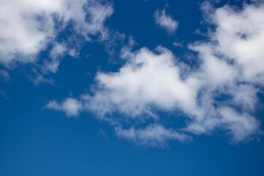 Beautiful sky background. Oddly shaped clouds in a blue sky.