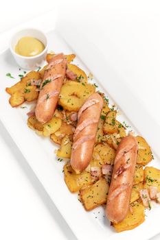 german organic cheese and pork sausages with fried potato and mustard on white background