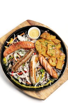 mixed german traditional organic sausage and potato meal platter including Nurenberger, Lamb and Pork with salad and mustard