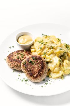 german frikadellen meatballs with creamy onion fried potatoes and mustard sauce on white background