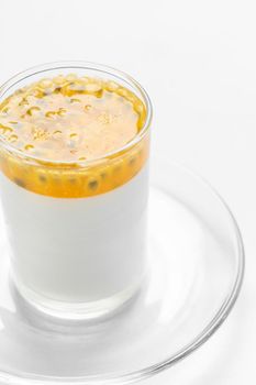 vegan dairy free organic coconut cream panna cotta with passion fruit dessert on white background