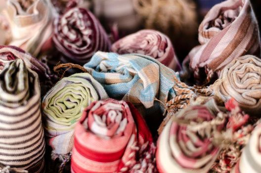 mixed traditional krama cotton scarf souvenirs detail on display at shop in angkor wat in cambodia