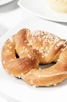 vegan dairy-free organic german traditional pretzel bread on white table