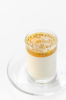 vegan dairy free organic coconut cream panna cotta with passion fruit dessert on white background