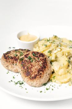 german frikadellen meatballs with creamy onion fried potatoes and mustard sauce on white background
