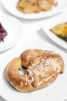 vegan dairy-free organic german traditional pretzel bread on white table