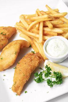 british traditional fish and chips meal on white plate