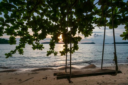 wood swing on empty beach in koh ta kiev paradise island near sihanoukville in cambodia