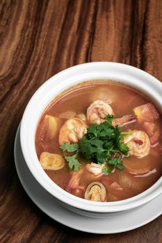 thai tom yum kung spicy and sour shrimp soup on wood table background in phuket thailand