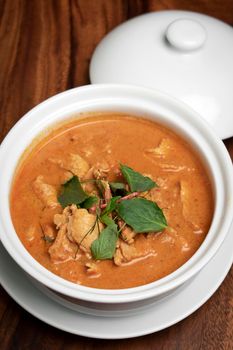 thai spicy panang pork curry with coconut milk on wood table in Phuket Thailand