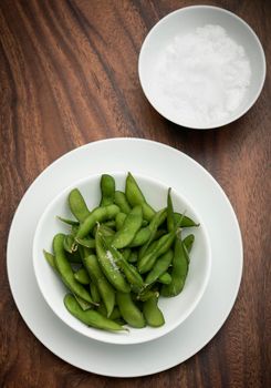 organic edamame beans snack in bowl on table with sea salt