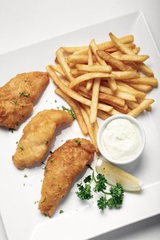 british traditional fish and chips meal on white plate
