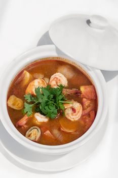 thai tom yum kung spicy and sour shrimp soup on white table background in phuket thailand
