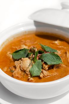 thai spicy panang pork curry with coconut milk on white table in Phuket Thailand
